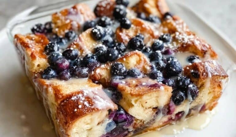 Blueberry French Toast Casserole with Vanilla Glaze in a square dish
