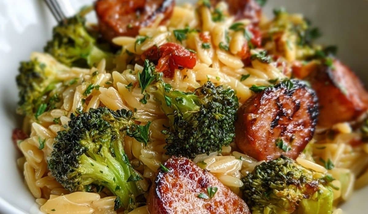 Chicken Sausage Broccoli Orzo served in white bowl with roasted broccoli and sausage