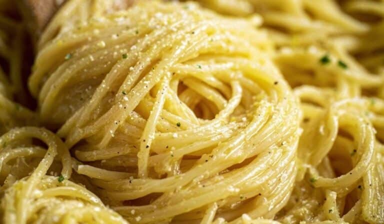Close-up of creamy Lemon Chicken Pasta twirled with Parmesan cheese