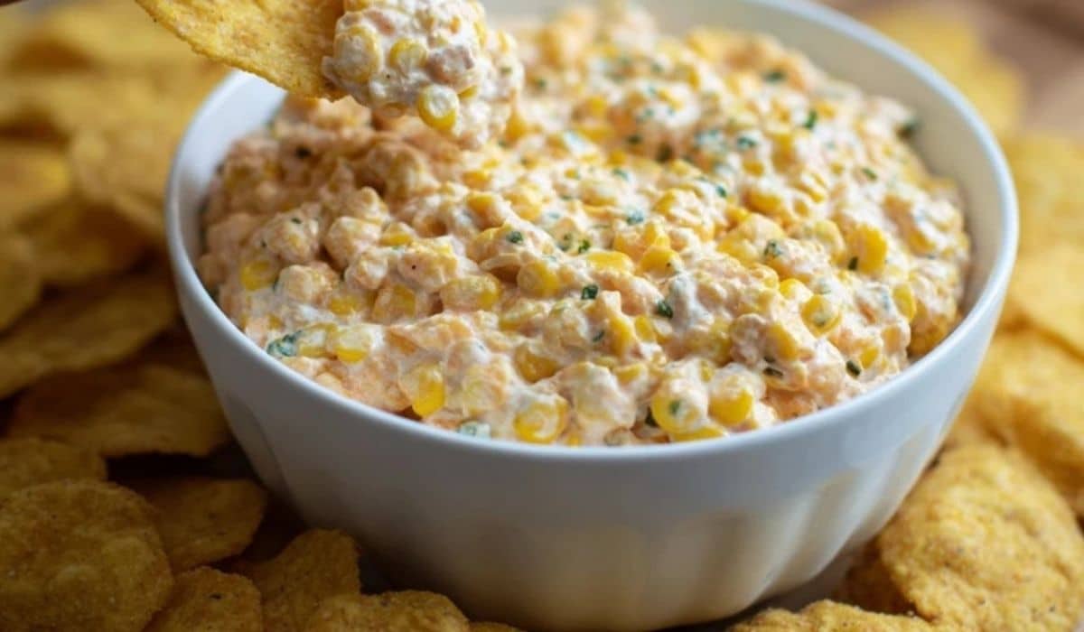 Out-of-this-World Corn Dip in a white bowl with tortilla chips
