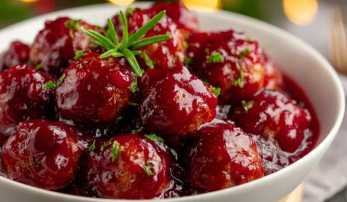 Best Christmas Cranberry Meatballs served in a white bowl with rosemary