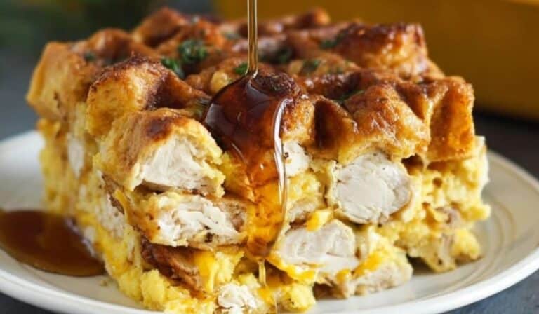 Chicken and Waffles Casserole served in thick layers with syrup drizzle