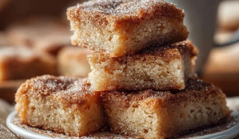 Easy Cinnamon Sugar Blondies stacked on a plate with cinnamon topping