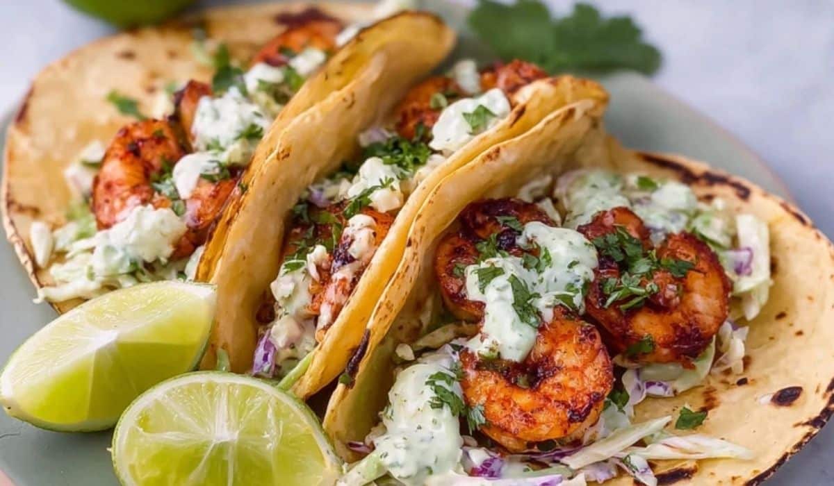 Cilantro Lime Shrimp Tacos with Creamy Slaw served with lime wedges on a green plate