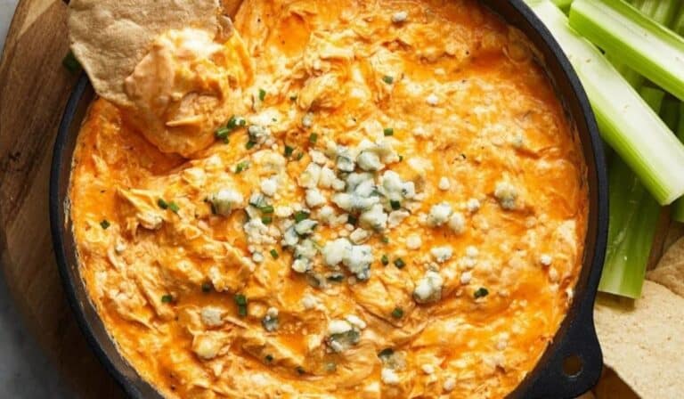 Classic Buffalo Chicken Dip served hot with tortilla chips and celery