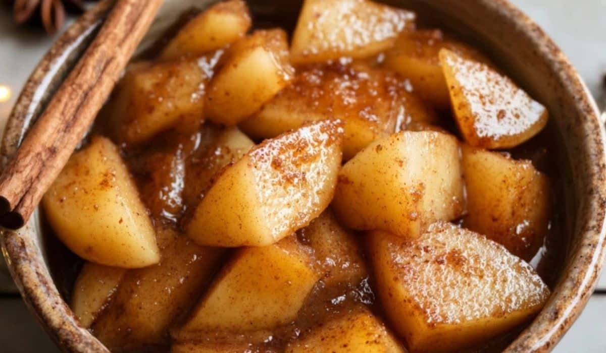 Crockpot Cinnamon Apples in a rustic bowl topped with cinnamon