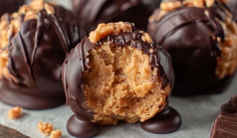 Featured image showing close-up of Peanut Butter Balls with Rice Krispies coated in dark chocolate