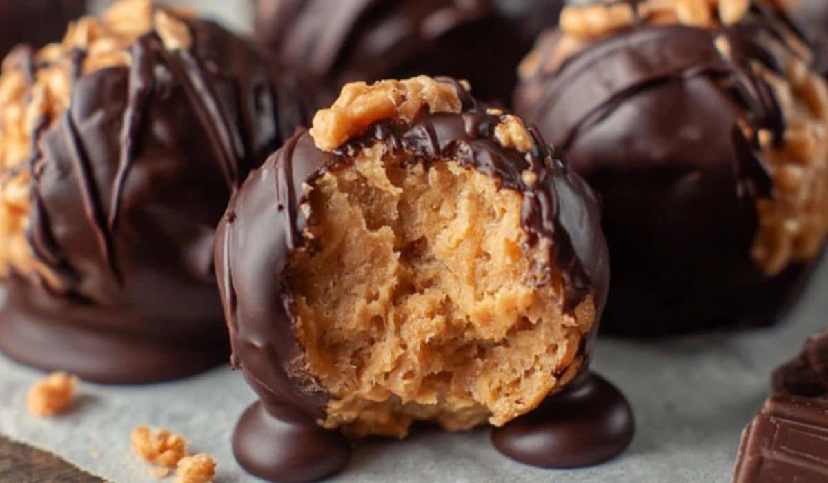 Featured image showing close-up of Peanut Butter Balls with Rice Krispies coated in dark chocolate