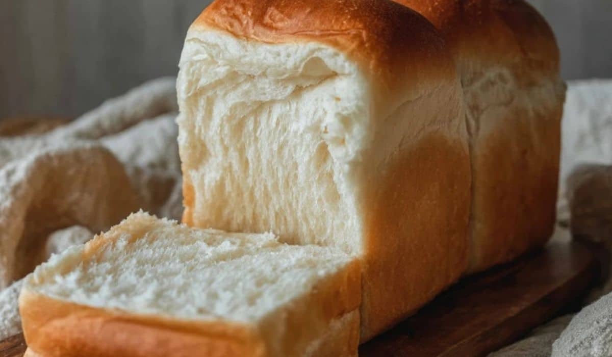 Simple Homemade Milk Bread sliced on a wooden board