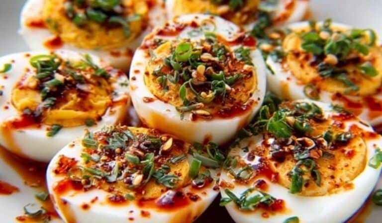 Spicy Chili Garlic Deviled Eggs with chili oil and herbs