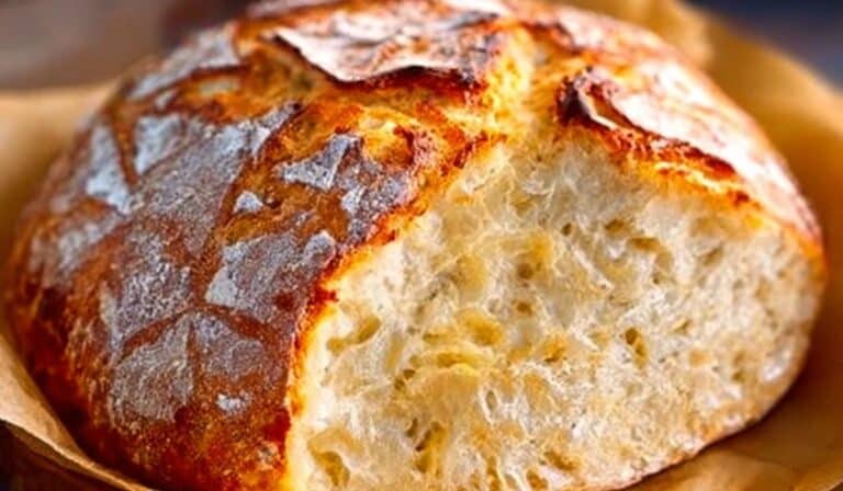 Crusty Dutch Oven No Knead Bread sliced open on a wooden board