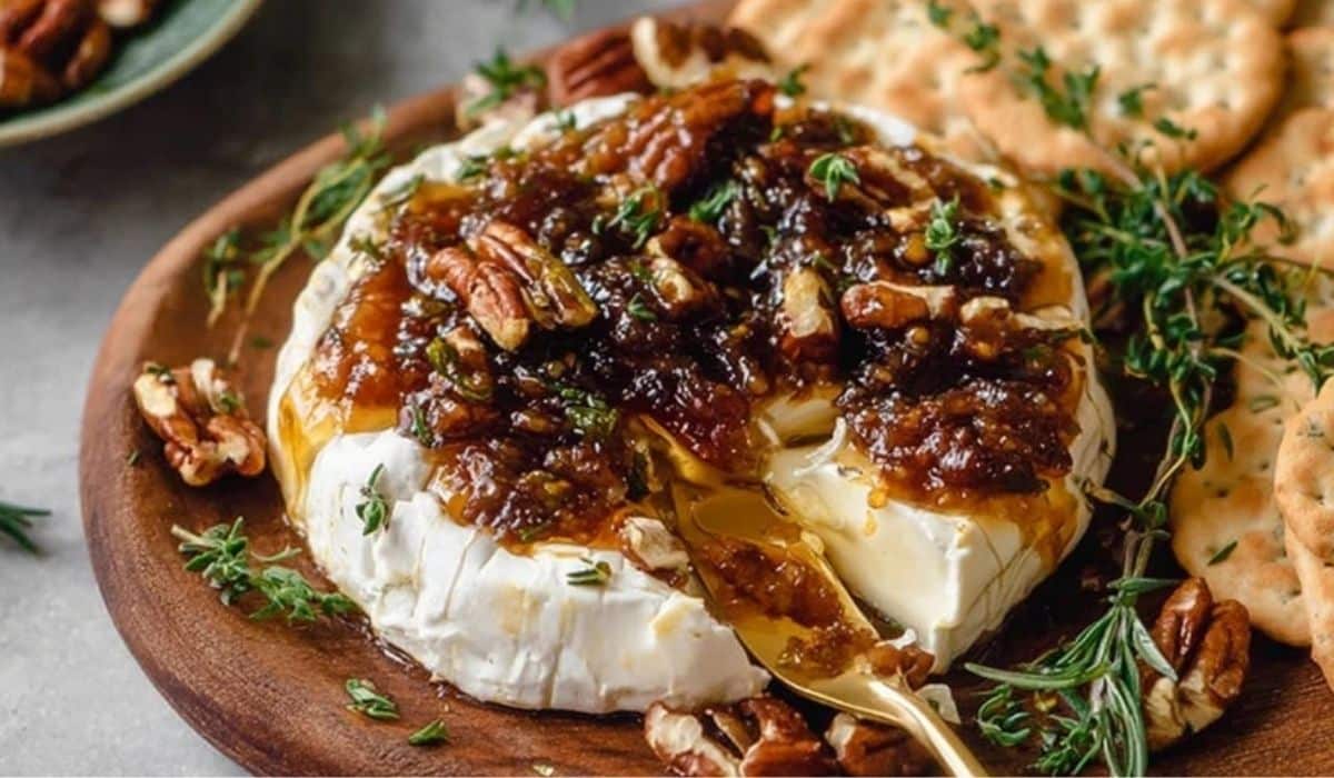 Easy Goat Cheese Appetizer with Fig Jam and Pecans on a wooden board