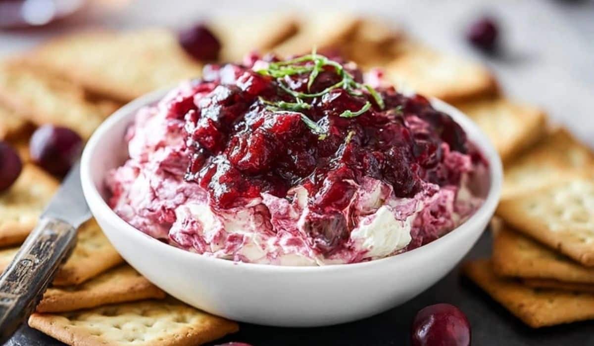 Irresistible Cranberry Cream Cheese Dip served in white bowl with crackers