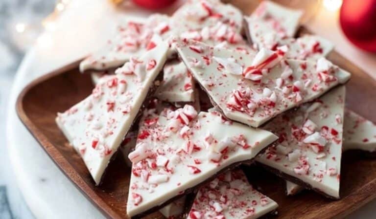 Peppermint bark served on a holiday tray with ornaments