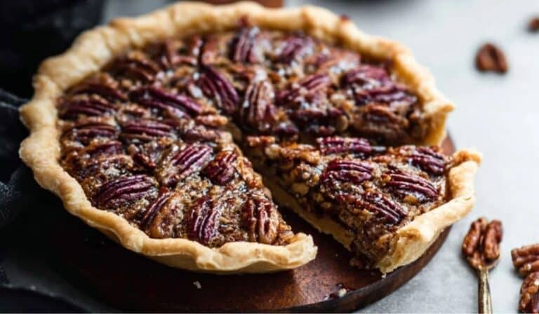 Maple Pecan Pie on rustic table with slice cut