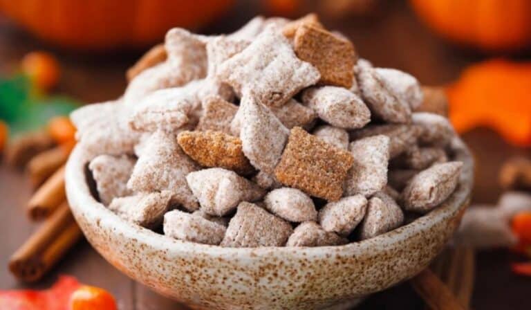 Pumpkin Spice Puppy Chow served in a rustic fall-themed bowl