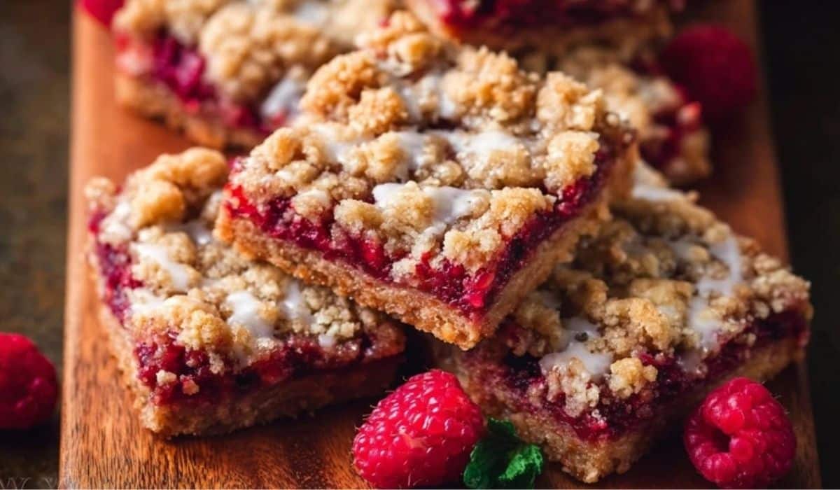 Raspberry Streusel Bars with golden crumb topping on wooden tray