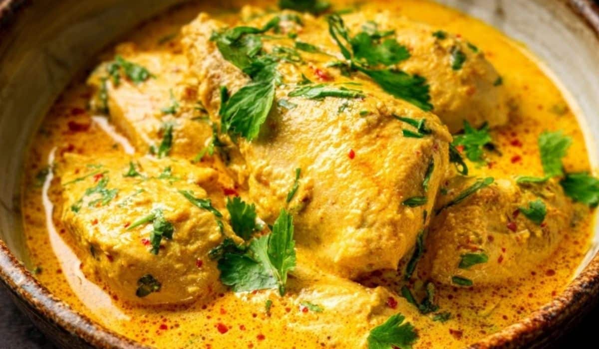 Delicious Brazilian Coconut Chicken in a rustic bowl with creamy coconut sauce