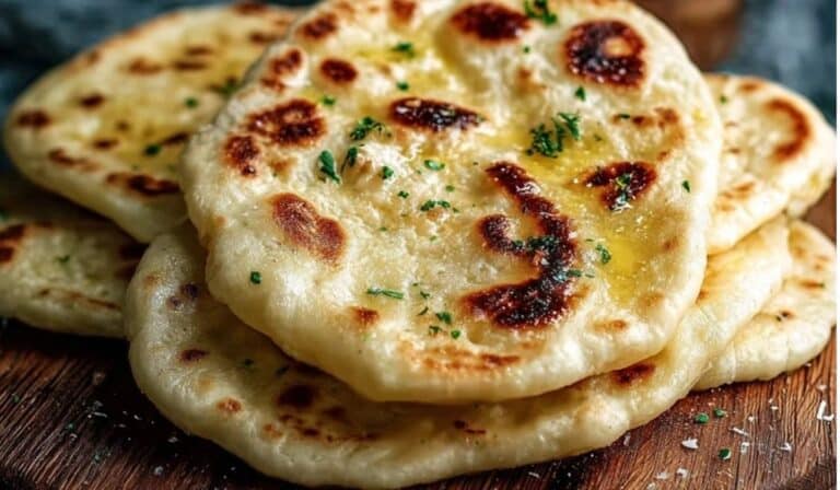Featured image of Quick and Easy Homemade Naan Flatbread on wooden board