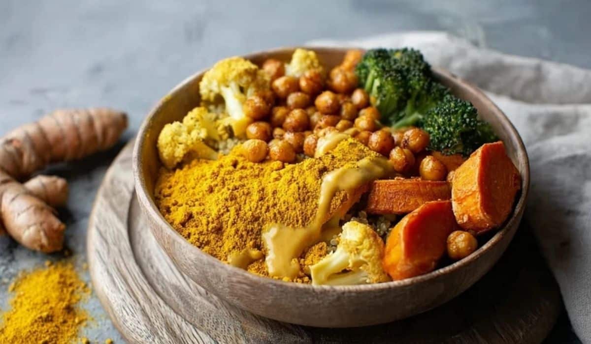 Anti-inflammatory golden turmeric bowl with roasted veggies, chickpeas, and tahini over quinoa.