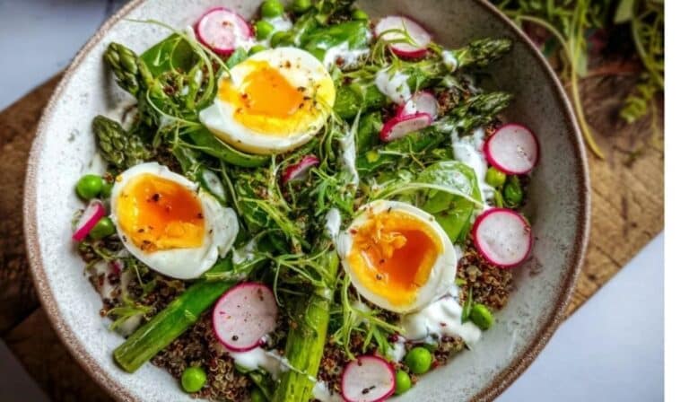 Asparagus and egg spring bowl with quinoa, peas, radishes, and jammy eggs