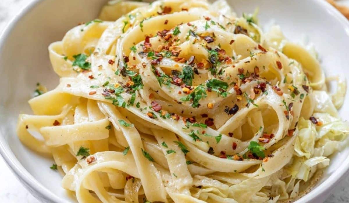 Butter cabbage fettuccine with garlic in a white bowl on a rustic table