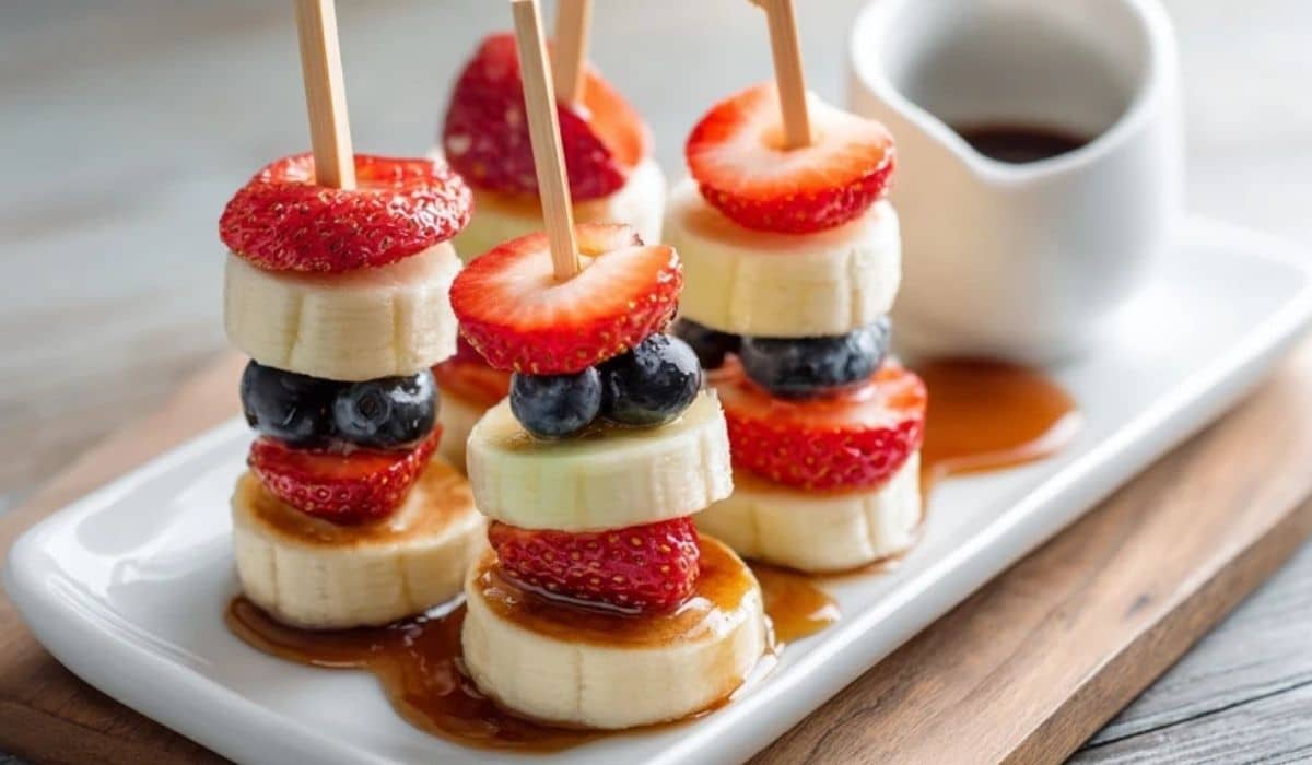 Mini pancake skewers with fruit on a brunch platter with maple syrupMini pancake skewers with fruit on a brunch platter with maple syrup