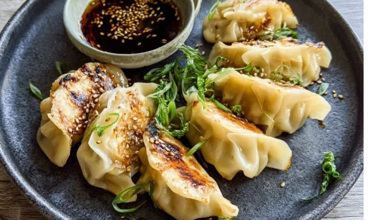 Pan-fried cabbage dumplings with crisp golden bottoms and dipping sauce