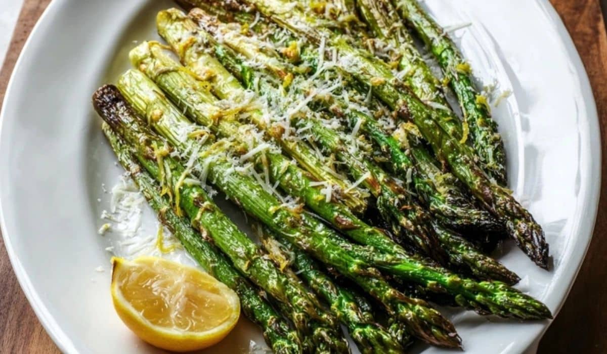 Roasted asparagus lemon parmesan on a platter with fresh lemon zest