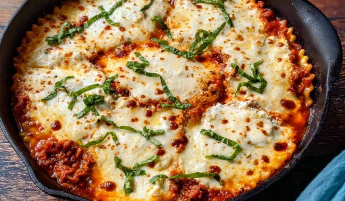 Skillet lasagna with ricotta in a cast iron skillet with golden cheese.